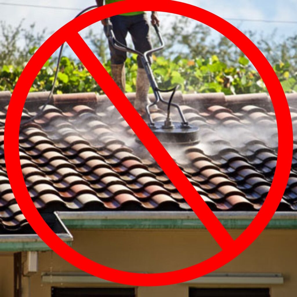 Improper way of cleaning a roof. A person is using a surface cleaner to pressure wash a roof.